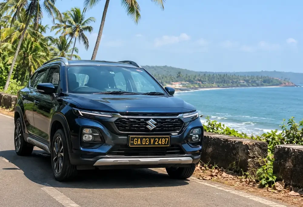Legal self-drive rental car with black and yellow number plate on a scenic coastal road in Goa
